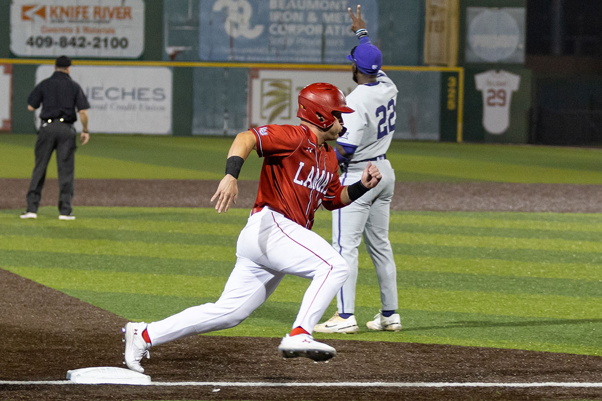 LU catcher Ryan Snell steps on the third base on his way to home plate against Kansas State University Feb. 22, at Vincent Beck stadium. UP photo by Brian Quijada.