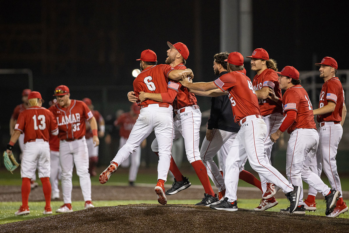 The Lamar baseball team celebrates with pitcher Daniel Cole after closing out the game against Kansas State University Feb. 22, at Vincent Beck stadium. UP photo by Brian Quijada.