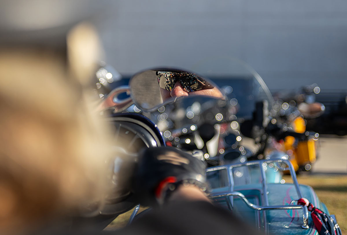 Adrian Michelle Bruce sits on her motorcycle as her sunglasses reflect from her custom mirrors at the Ladies in Leather parade & rally, in Teddy Morse's Cowboy Harley-Davidson in Beaumont, Texas, Sep. 7. UP photo by Brian Quijada.