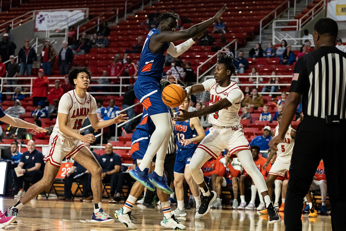 LU guard Jakevion Buckley passes the ball under the basket to his teammate, Feb. 16, at the Montagne Center. UP image by Brian Quijada.