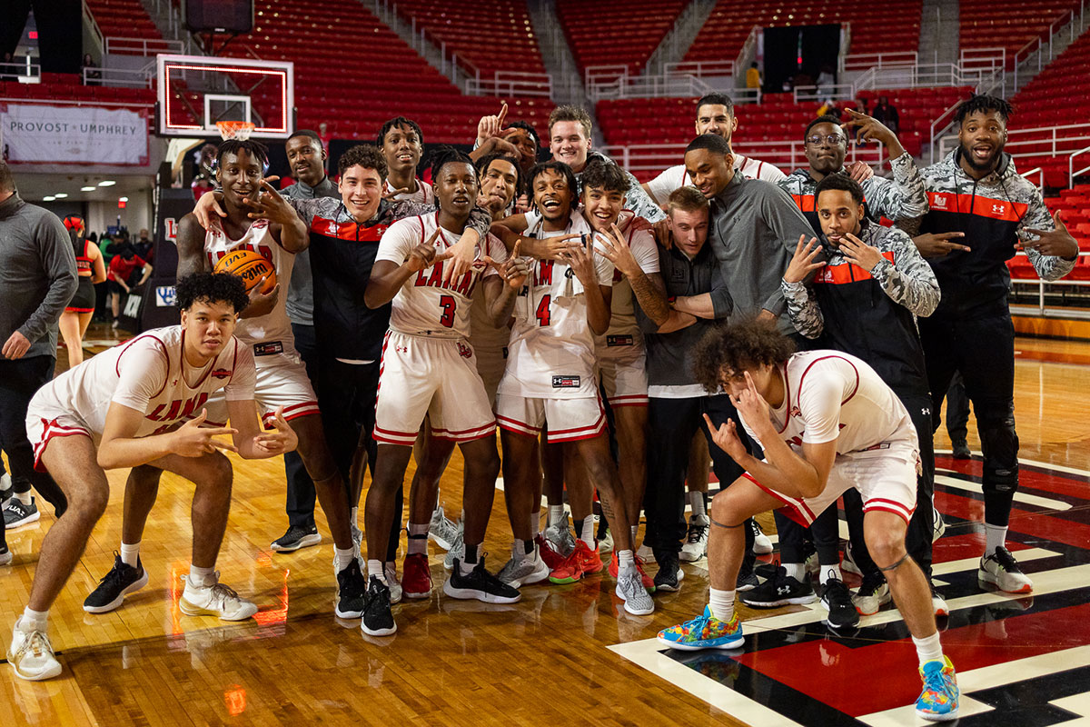 The Lamar University men’s basketball team poses for a picture after beating the Texas A&M-Corpus Christi Islanders 68-66, Jan 19, at the Montagne Center. UP image by Brian Quijada.