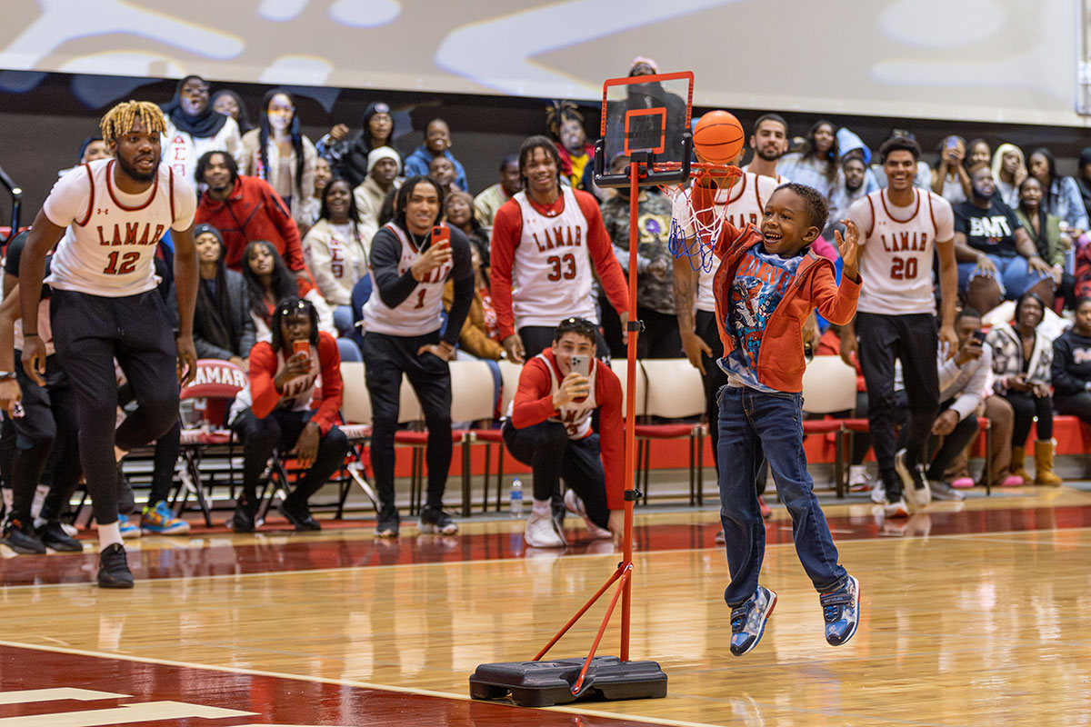 M.J. McLean, son of men’s assistant basketball coach Mikhail McLean, dunks the ball as part the children's dunk contest during McDonald Mayhem, Oct. 30, in McDonald Gym. UP photo by Brian Quijada.