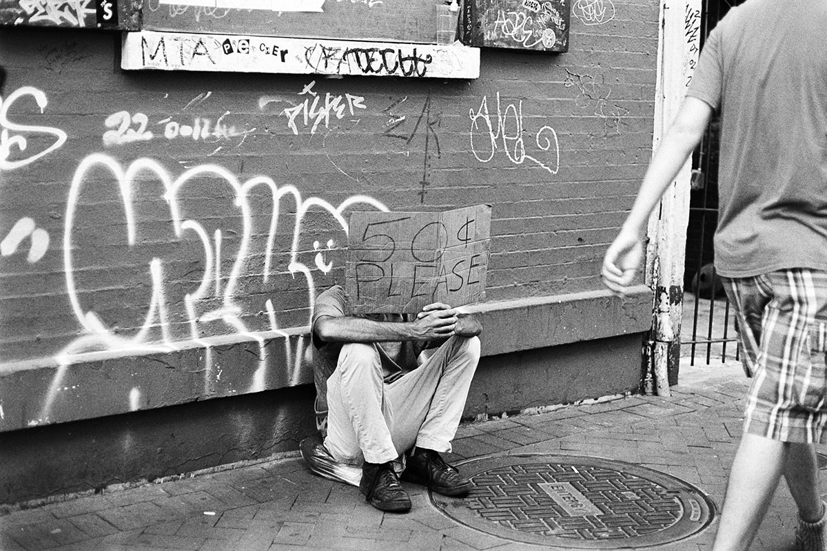 A homeless man sits on a Bourbon Street sidewalk with a sign begging for 50 cents in New Orleans, June 4, 2022. UP photo by Brian Quijada.