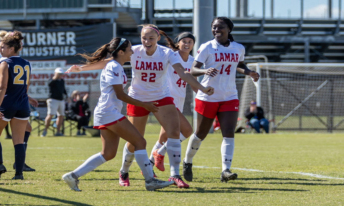 Cardinal midfielder Alana Clark celebrates with her teammates after scoring the first game tying goal against the University of Texas A&M-Commerce Lions, Oct. 15, at the Lamar University Soccer Complex.