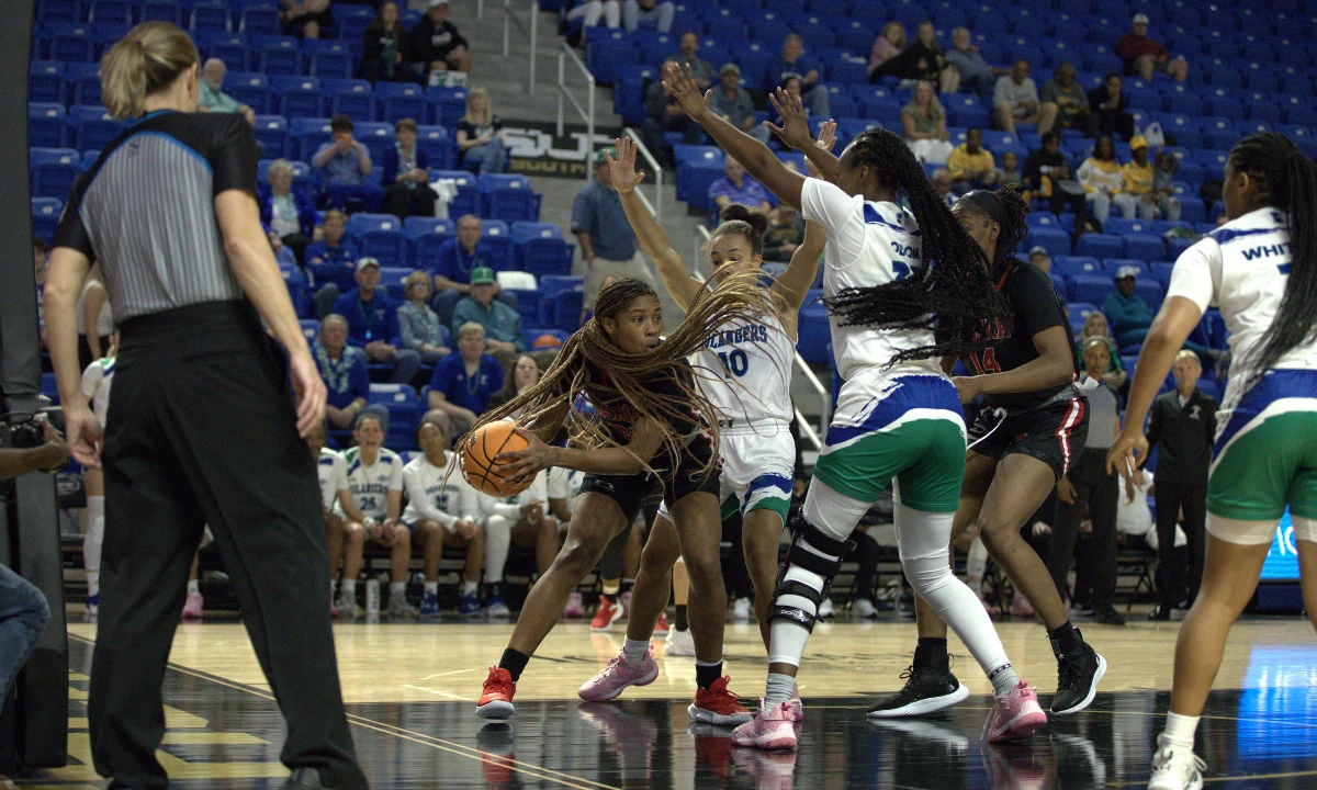 Lamar's NJ Weems fights off several Islander defenders, March 8 at the Legacy Center in Lake Charles, Louisiana. Photo credit: Brian Quijada, UP photo editor.