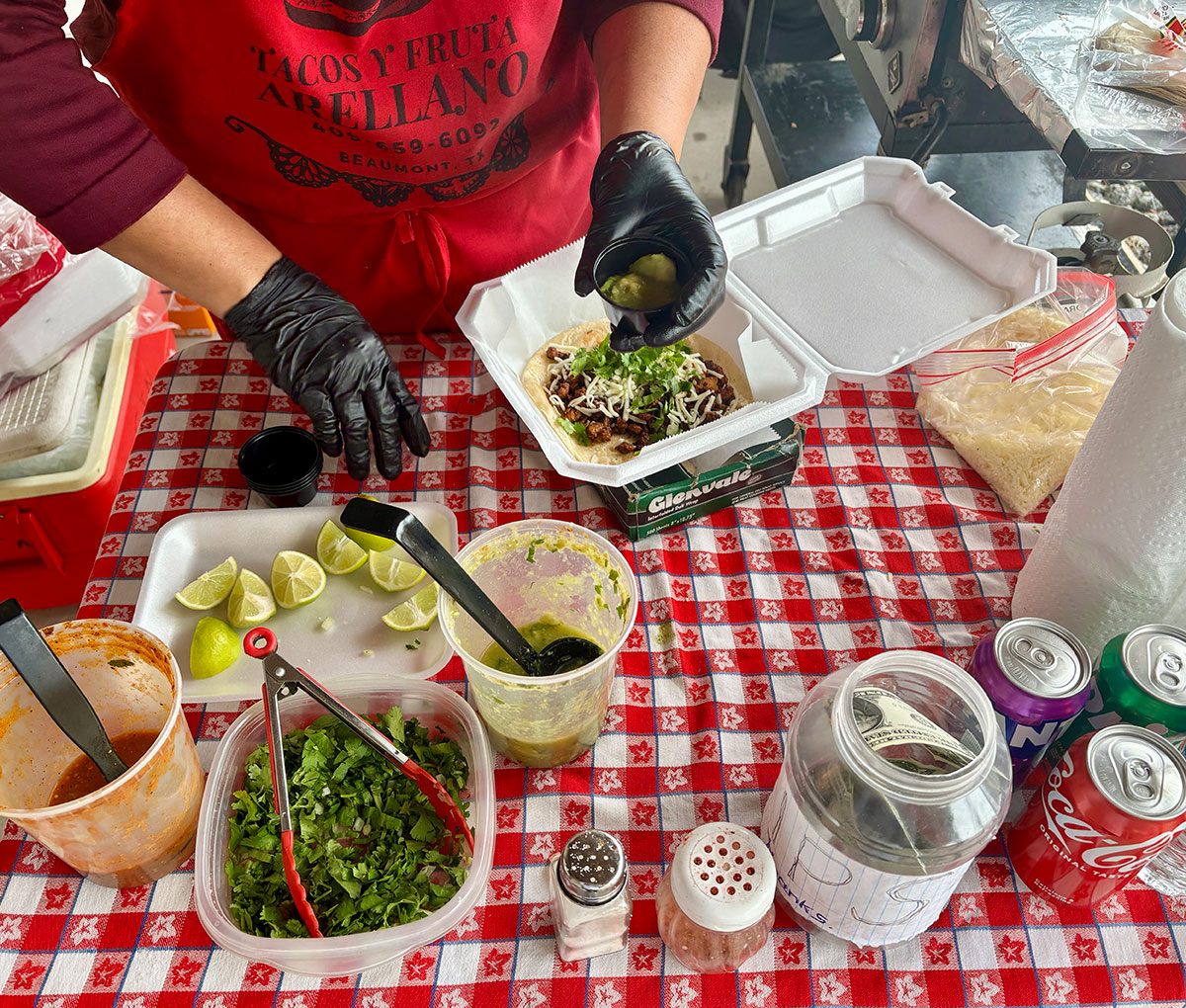 Gloria Arellano, owner of Tacos Y Fruta, serves pork tacos at Spindletop Gladys City Boomtown Museum, Feb. 8
