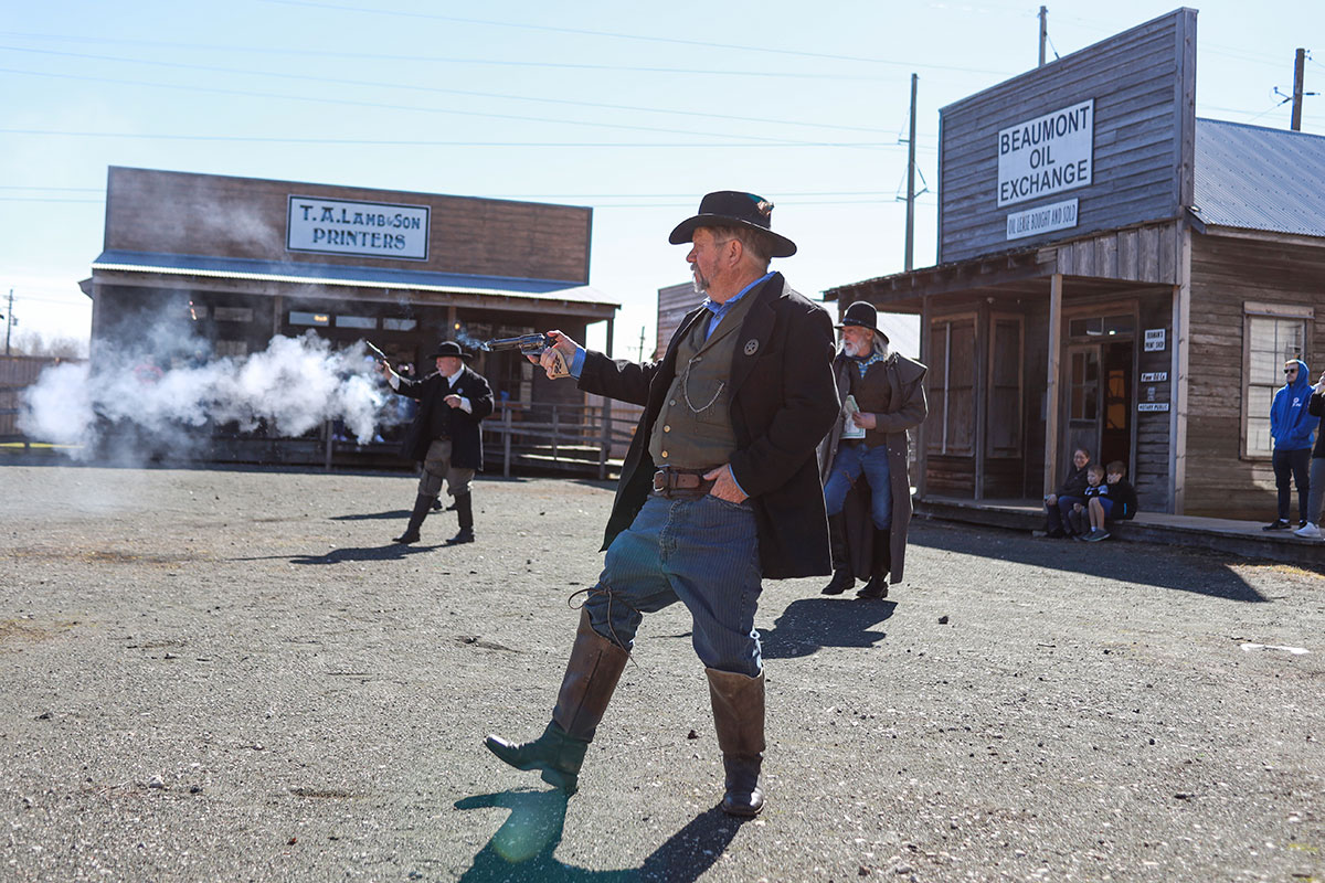 A Big Thicket Outlaws re-enactor shoots his revolver as part of a reenactment during the 123rd Spindletop Anniversary at the Spindletop Gladys-City Boomtown Museum, Jan. 13. UP photo by Brian Quijada.