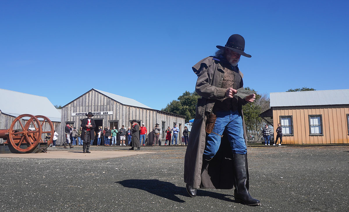 A Boomtown reenactor looks at a sheet of paper as part of a reenactment during the 123rd Spindletop Anniversary at the Spindletop Gladys-City Boomtown Museum, Jan. 13. UP photo by Carlos Viloria.