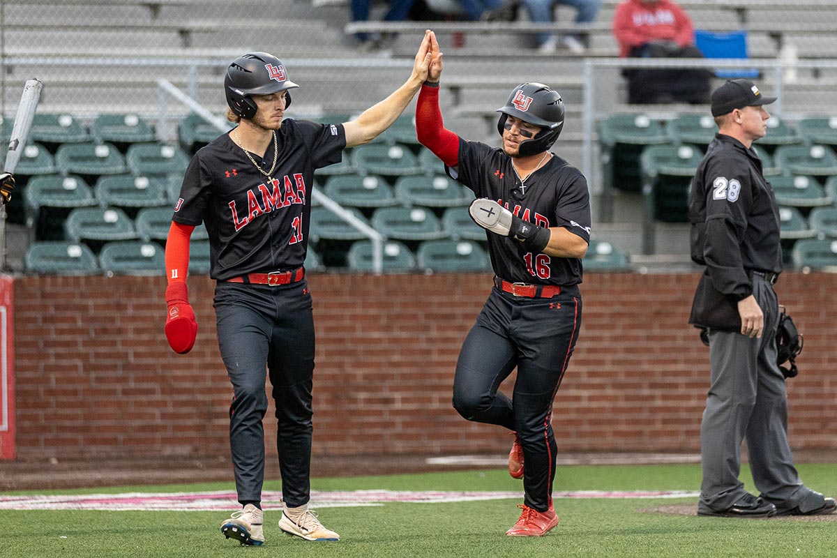 Lamar infielder Kanin Dodge high fives Drake Varnado after scoring a run against Prairie View A&M University, at the Vincent-Beck Stadium, March 19. UP photo by Brian Quijada.