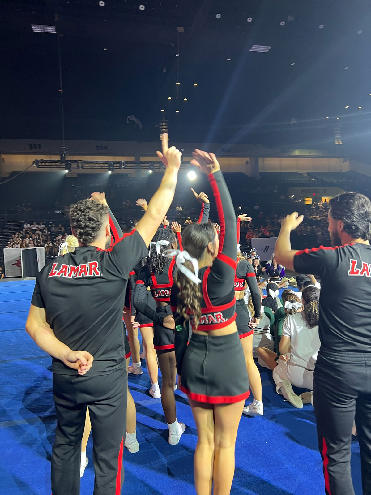 Members of the LU cheer program give the “L’s Up” sign during national competition in Daytona Beach, Fla., April 12.