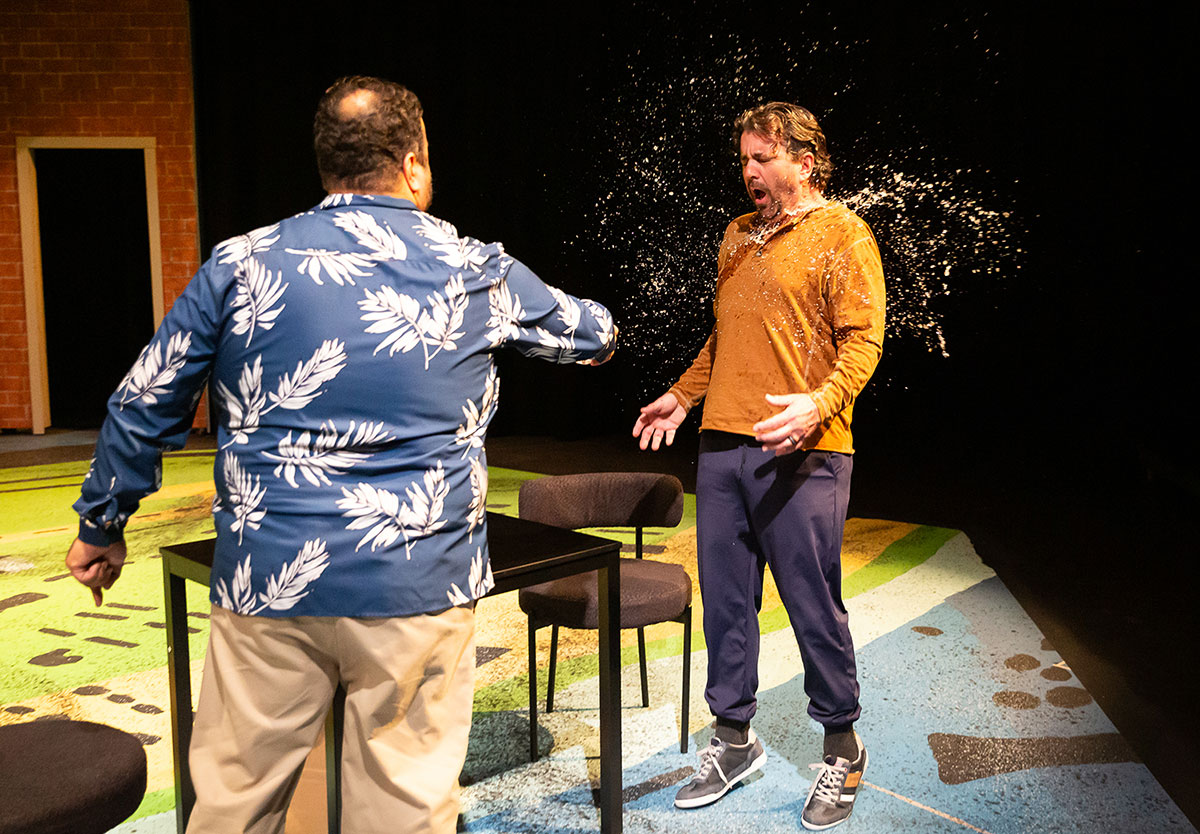 Dan (Orlando Arriaga), left, splashes water at Ned (Joseph Lyle Taylor) in "Landscape With Weapon" which continues Feb. 2-4. Courtesy photo by Lynn Lane.
