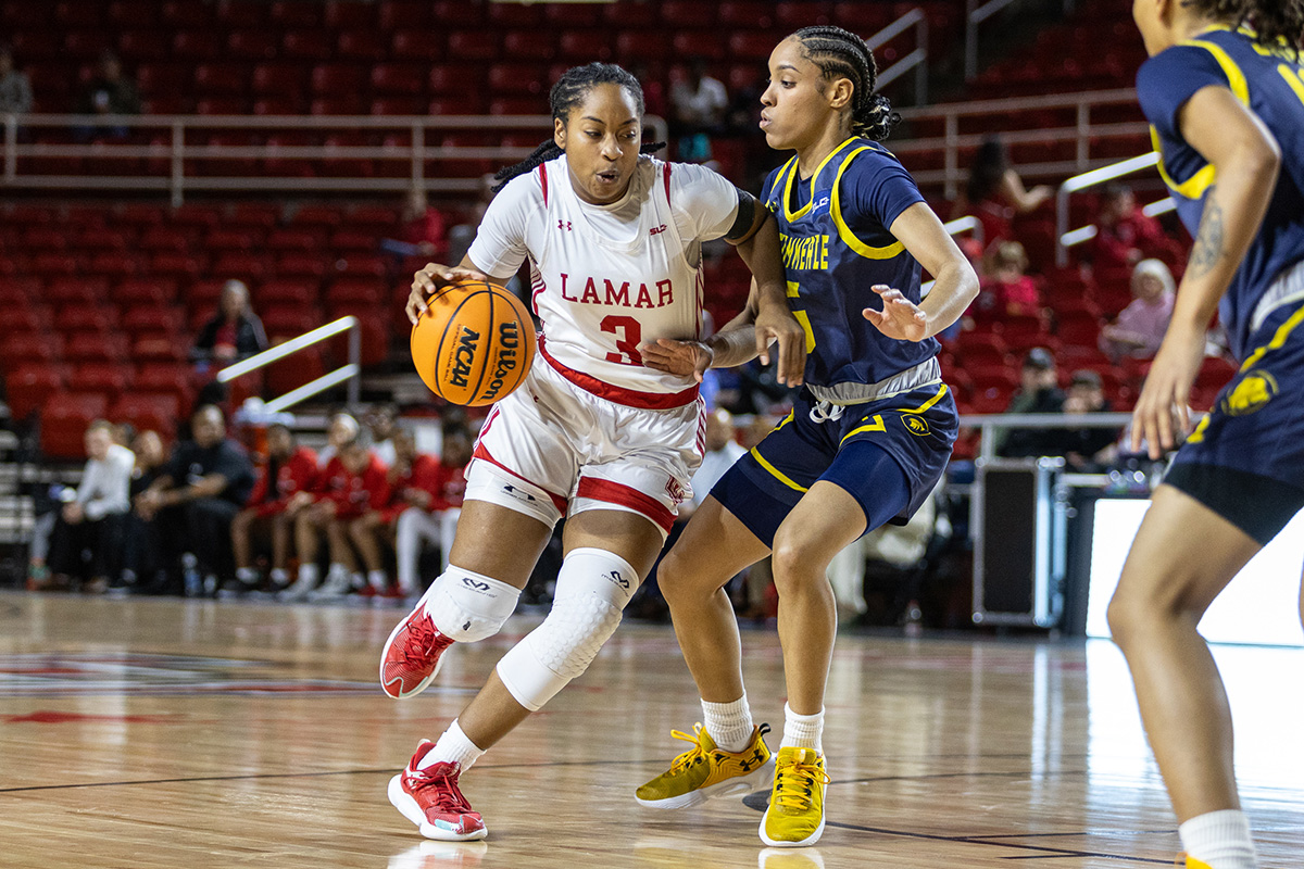 Cardinal guard Sabria Dean dribbles past TAMU-C defender, Jan. 18, in the Montagne Center. UP photo by Brian Quijada.