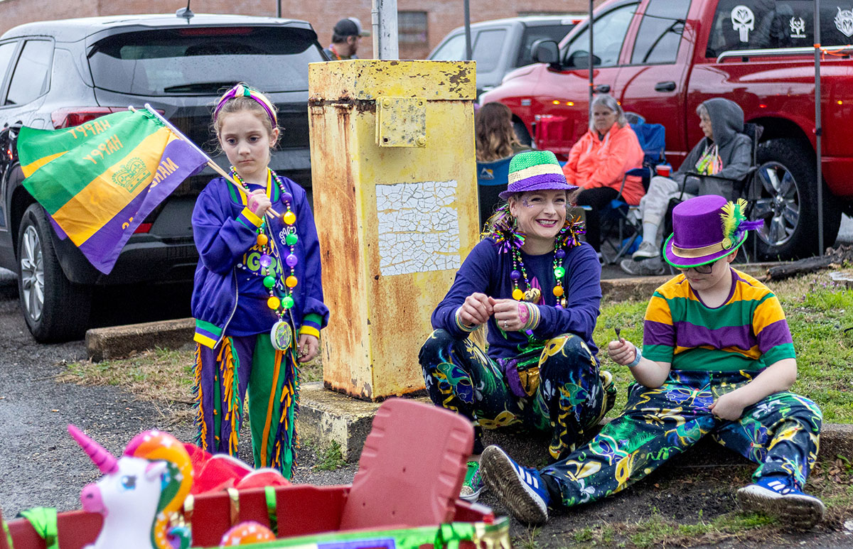 A little girl and her family wait for the floats during the Mardi Gras of Southeast Texas parade, in downtown Beaumont, Feb 11. UP photo by Brian Quijada.