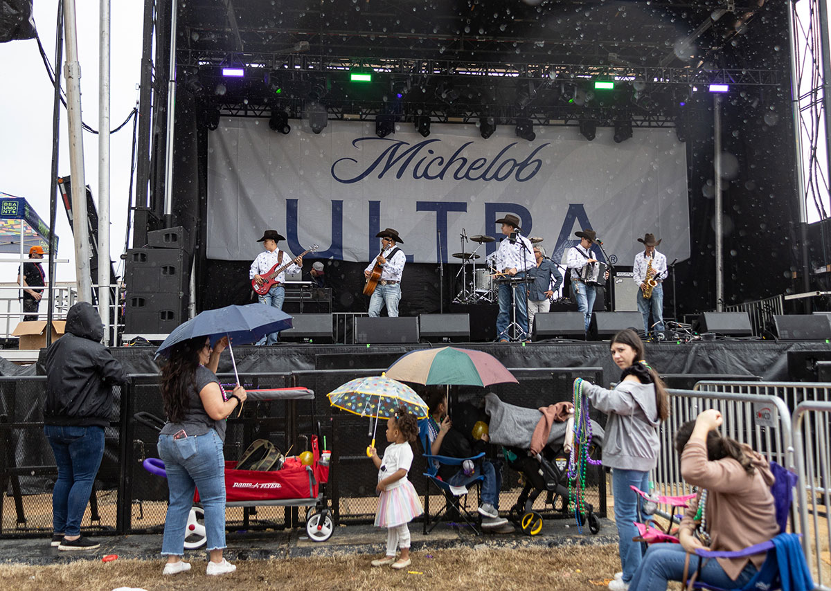 Sonido Master rehearses in the rain before performing for the Mardi Gras of Southeast Texas parade, in downtown Beaumont, Feb 11. UP photo by Brian Quijada.