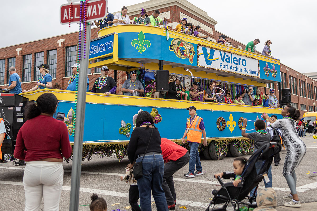 Valero Port Arthur Refinery’s float throws beads to the crowd during the Mardi Gras of Southeast Texas parade, in downtown Beaumont, Feb 11. UP photo by Brian Quijada.