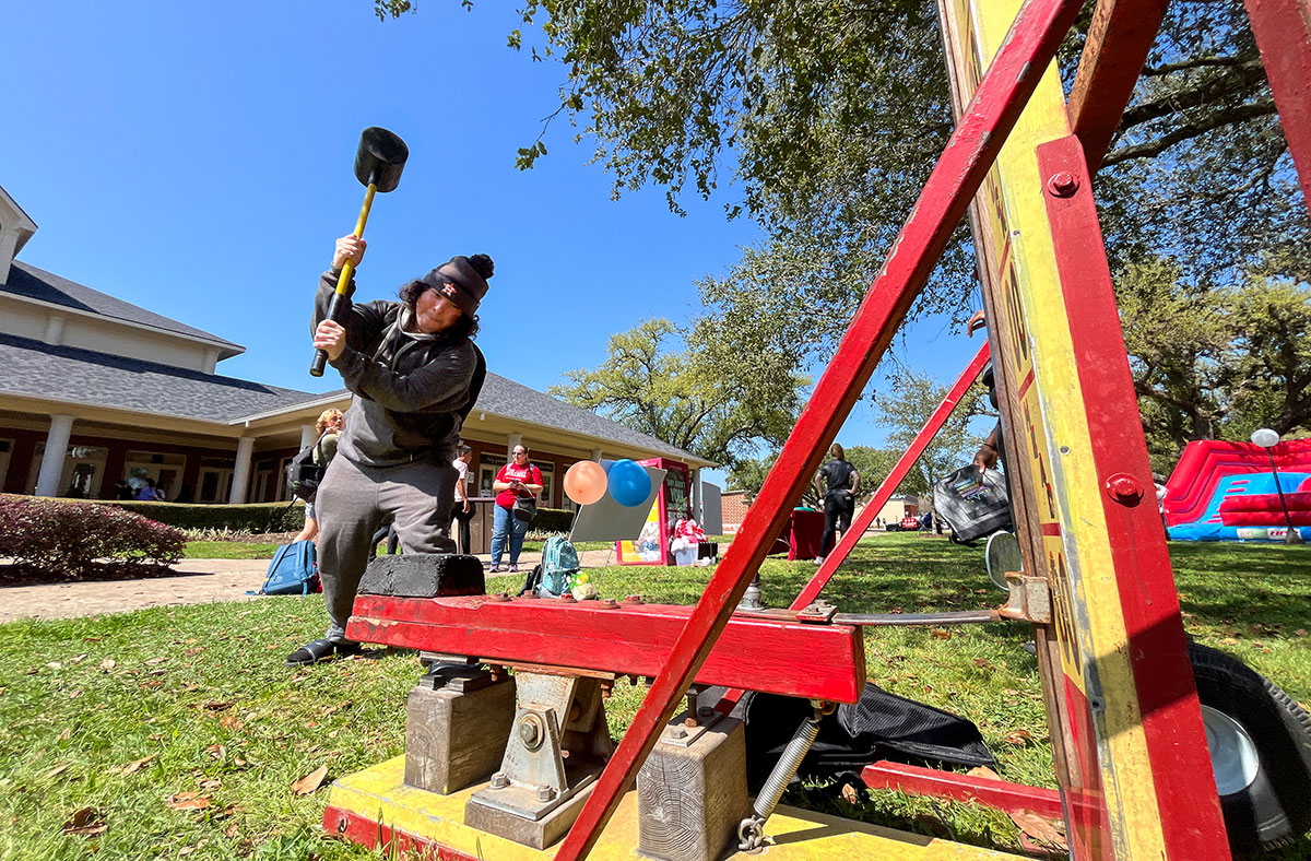 A student hammers down on the high striker during the Lamar University 100 Year Celebration, Mar. 5, in the Dining Hall Lawn. UP photo by Brian Quijada.