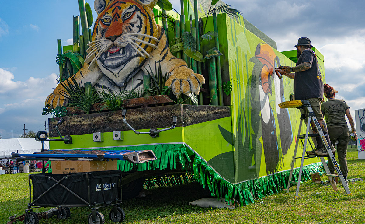 Artist, Laced and Found painting a parade float. During Mural Fest 2024, Saturday March 2nd.