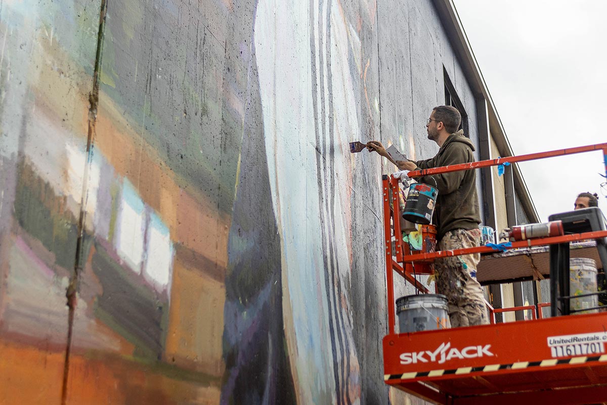 Sebas Velasco paints part of his mural during the Mural fest in downtown Beaumont, TX, March 3. UP photo by Brian Quijada.