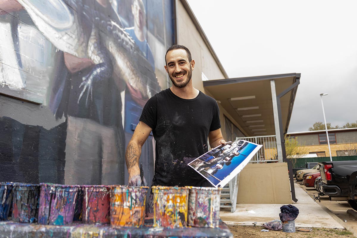 Slim Safont smiles while preparing his paint during Mural fest in downtown Beaumont, TX, March 3. UP photo by Brian Quijada.