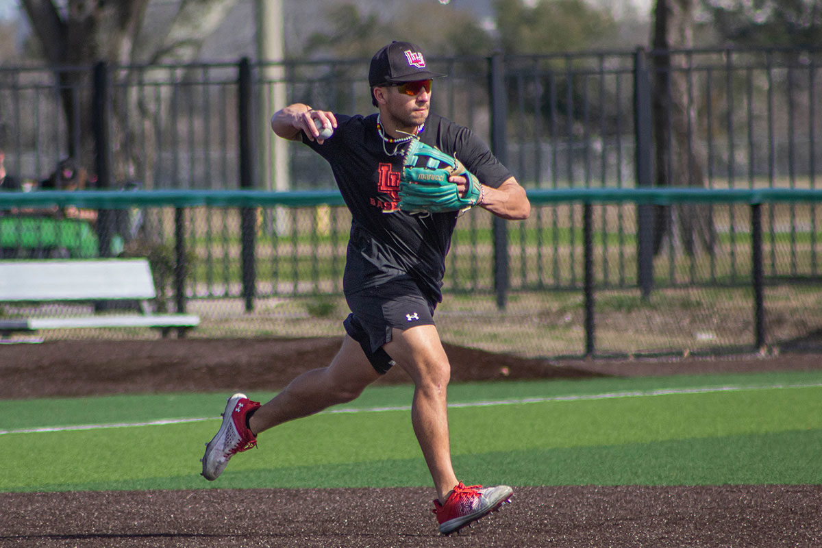 LU infielder Ethan Ruiz throws a ball during practice, Feb. 1, at the Vincent-Beck stadium.