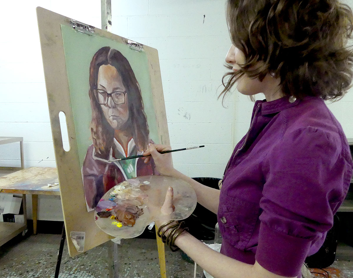 Olivia Cobb works on a portrait in Lamar University’s art house. Cobb is recruiting members of the Lamar community for her McNair project. UP photo by Gracie Anderson.