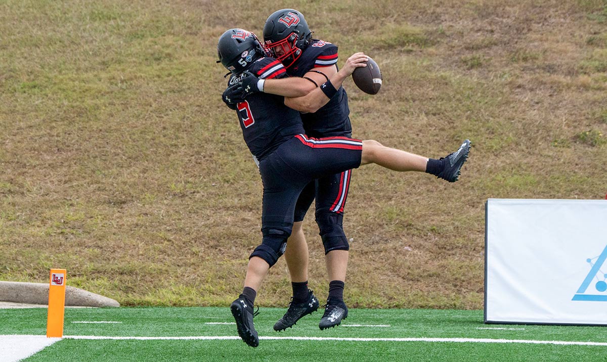 Cardinal quarterback Robert Coleman (left) and tight end Morgan Sampson (right) celebrate a touchdown against Southeastern Louisiana, Nov. 2, at Provost Umphrey Stadium. UP photo by Carlos Viloria.