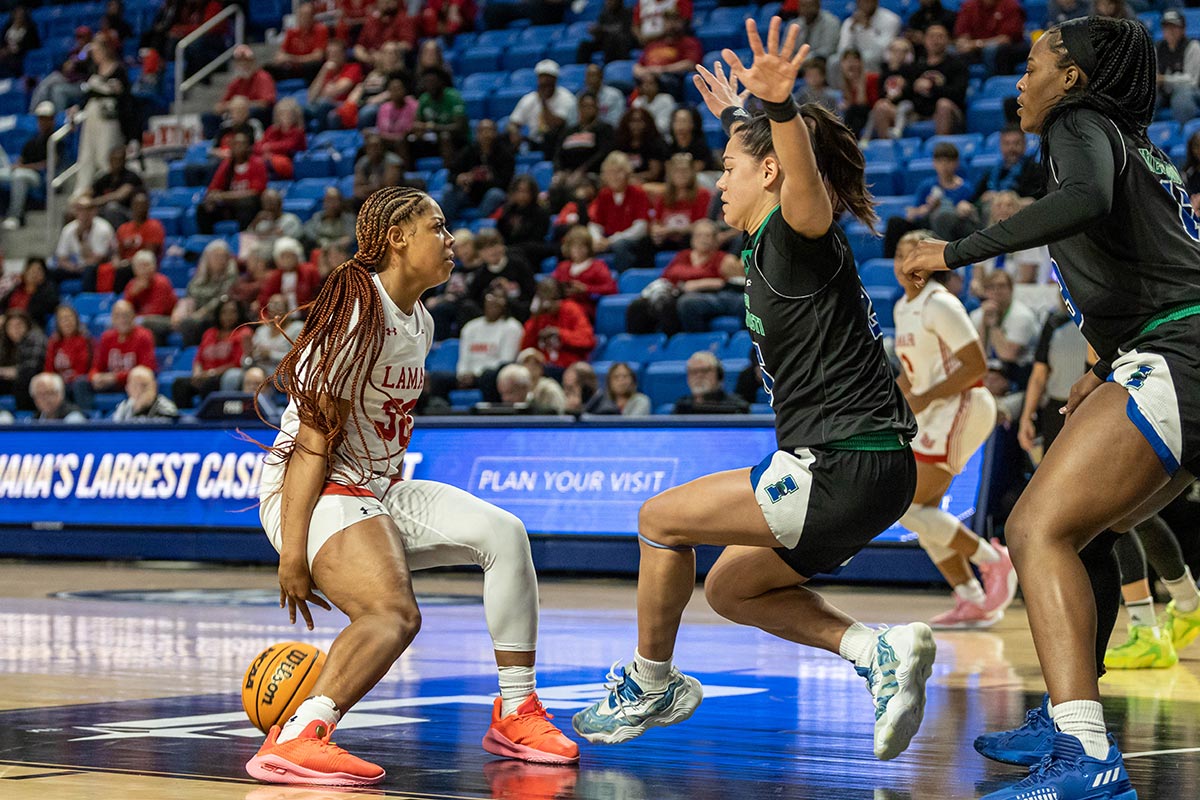 LU guard R’Mani Taylor crosses up a Texas A&M Corpus-Christi defender during the Southland Conference tournament final, in The Legacy Center, Lake Charles, La. March 14. UP photo by Brian Quijada.