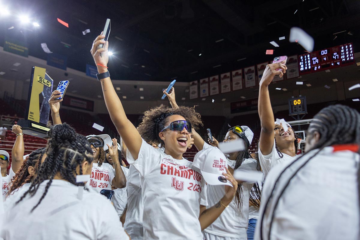 The Lamar women’s basketball team celebrates during the Southland Conference regular season trophy presentation, in the Neches Arena at the Montagne Center, Mar. 7. UP photo by Brian Quijada.