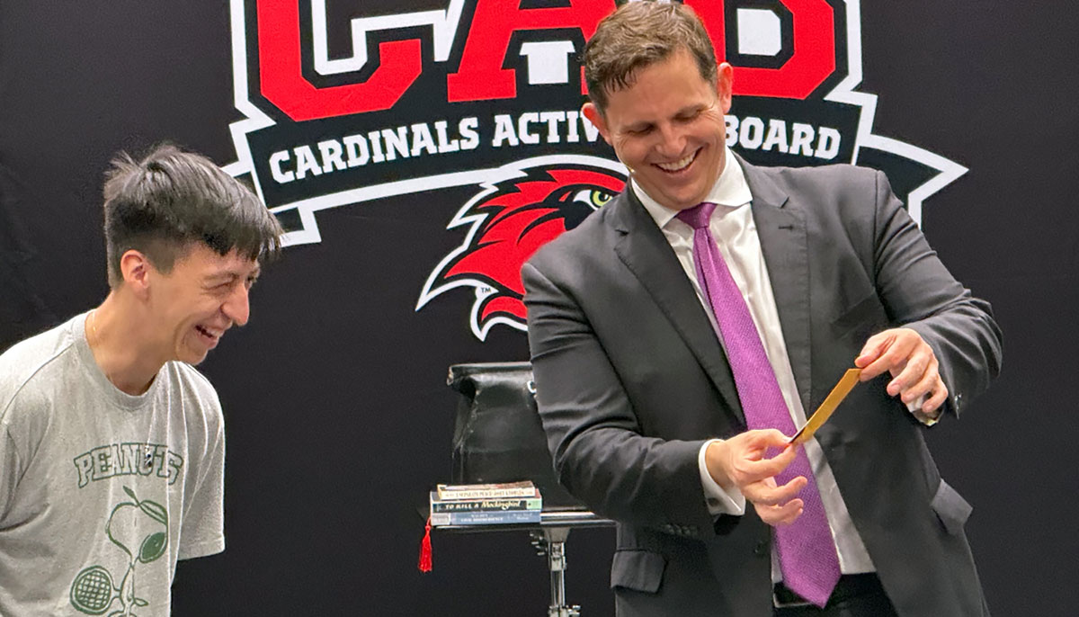 Magician Benjamin Jackson shows a trick to an audience volunteer in the Lamar University Science Auditorium, Sept. 20.