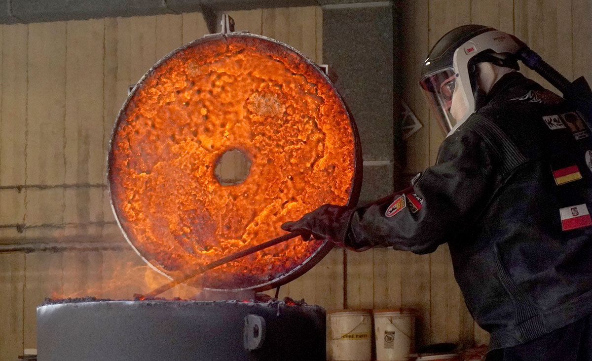 Lamar art professor Kurt Dyrhaug presses on pieces of iron into the furnace, March 22, at the art foundry. UP photo by Carlos Viloria.