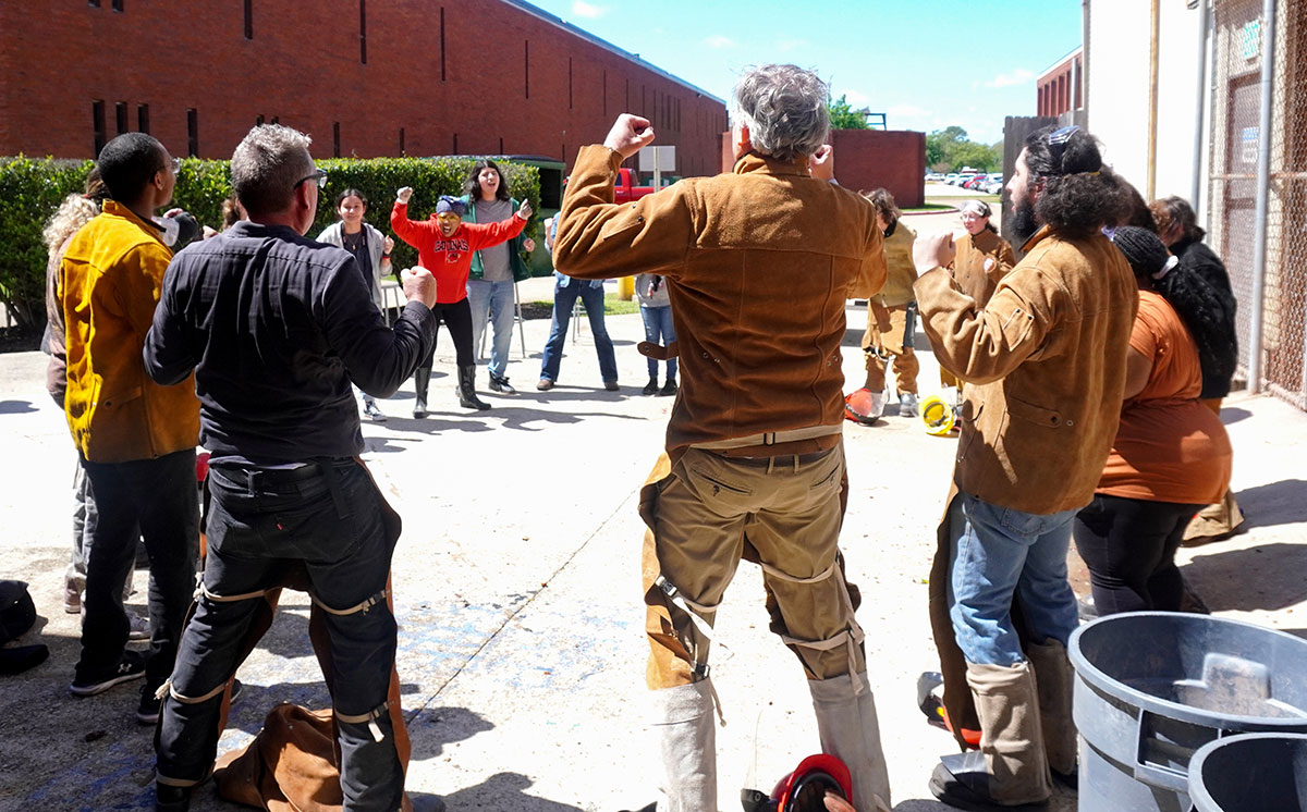 All the participants of the Iron Pour celebrating together that the event ended successfully, March 22, outside the art foundry. UP photo by Carlos Viloria